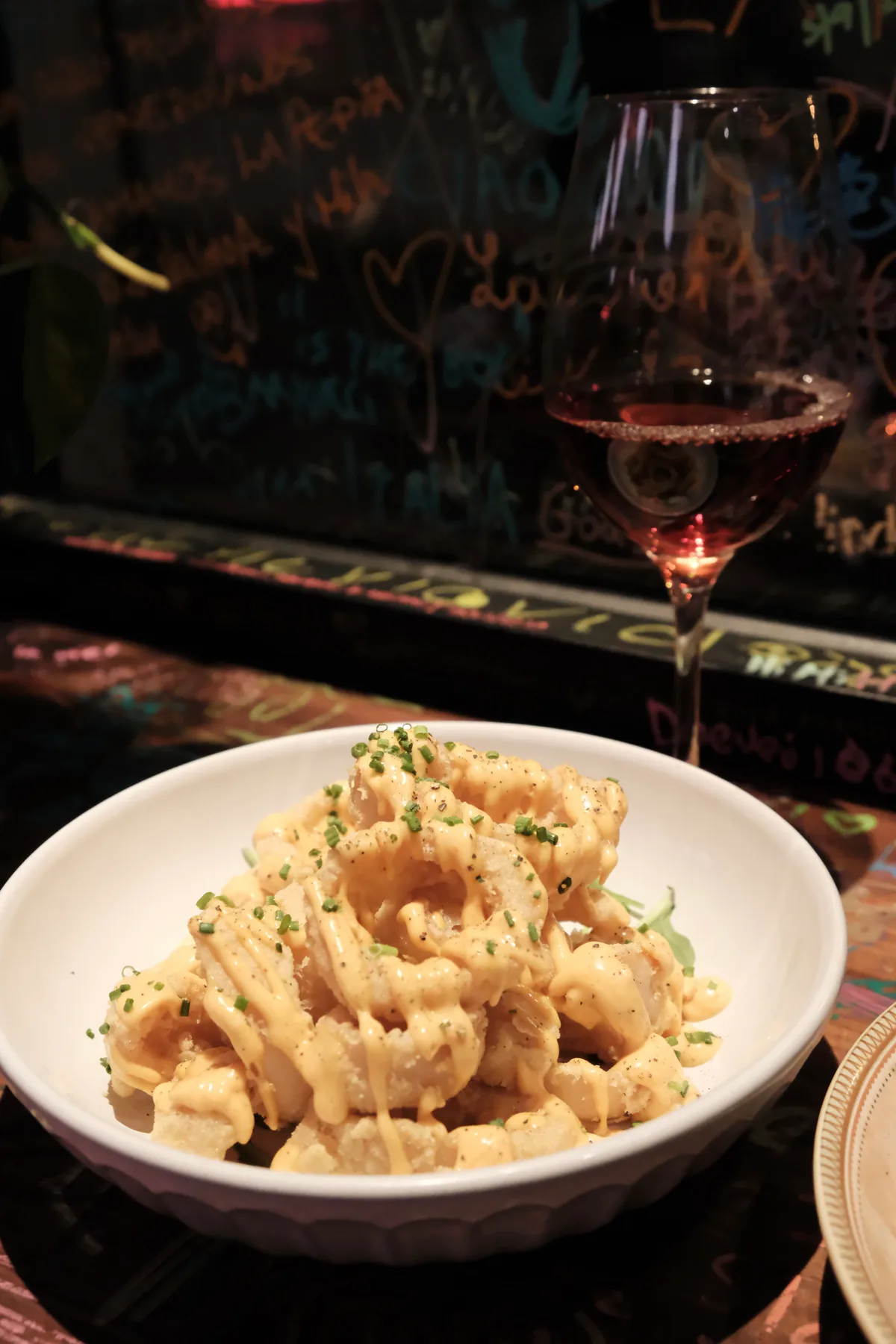 Crispy calamari covered with a creamy peppered sauce and chopped chives