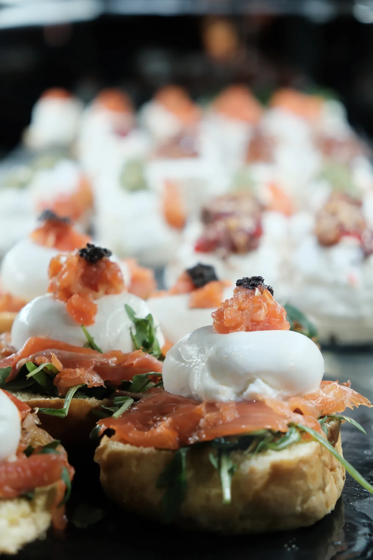 Pinchos topped with smoked salmon, soft cheese, herbs, and caviar